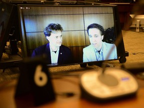 Marc Kielburger, screen left, and Craig Kielburger, screen right,  appear as witnesses via videoconference during a House of Commons finance committee in the Wellington Building in Ottawa on Tuesday, July 28, 2020.