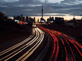 Vehicle lights are seen as commuters travel into Toronto on the Gardiner Expressway in the early morning hours of Jan. 27, 2017. Highway 413 is needed north of the GTA to ease congestion and facilitate growth, writes Brian Lilley.