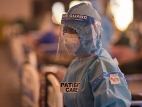 A medical worker at a banquet hall, which was converted into an isolation center to handle the rising cases of infection on April 15, 2021 in New Delhi, India.