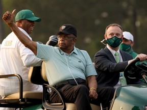 Lee Elder, centre, waves to the crowd after the opening ceremony of the Masters at Augusta National Golf Club in Augusta, Ga., on April 8.