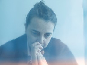 Long COVID sufferer Teresa Dominguez, 55, a social worker specialising in disabilities, poses for a photograph taken through blue plastic, in Collado Villalba, Spain, March 4, 2021. The photograph was taken through blue plastic to visualise the effects of long COVID.