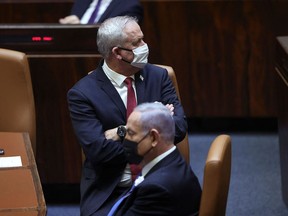 Israeli Prime Minister Benjamin Netanyahu (R) and Defense Minister Benny Gantz attend the swearing-in ceremony of Israel's Knesset (parliament) in Jerusalem, on April 6, 2021.