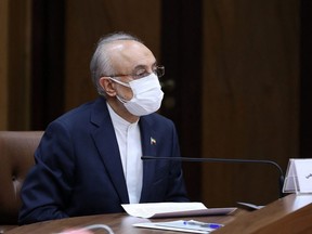 A handout picture provided by the Iranian presidential office on April 10, 2021, shows the head of the Atomic Energy Organisation of Iran, Ali Akbar Salehi, listening as the country's president (not pictured) delivers a speech on Iran's National Nuclear Technology Day, in the capital Tehran.