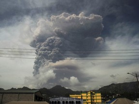 Ash and smoke billow as the La Soufriere volcano erupts in Kingstown on the eastern Caribbean island of St. Vincent on April 9