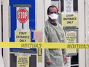A health care worker stands outside a SARS assessment entrance at York Central Hospital in Richmond Hill, Ont., April 21, 2003.