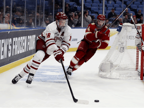 Cale Makar, left, of the Massachusetts Minutemen in action during the semifinals of the NCAA Men's Frozen Four on April 11, 2019 in Buffalo, New York.