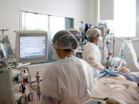 Medical staff members work in the Intensive Care Unit (ICU) where patients suffering from COVID-19 are treated at ELSAN's private hospital Clinique Oceane in Vannes, France, April 7, 2021.