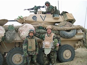 Matthew Fisher (right), inside Iraq in March 2003, with Lance Corporal Mark Cattabay and Lance Corporal Beaut Mattiota in the turret of the Black Six, a Canadian-built light armoured vehicle.