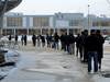 People line up outside a community centre in Fort McMurray for a COVID-19 vaccine on April 23, 2021.