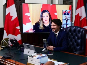 Prime Minister Justin Trudeau is joined virtually by Finance Minister Chrystia Freeland as they talk online to a group of front-line pharmacists from across the country on April 20.