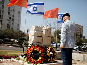 A man stands still as a two-minute siren marks the annual Israeli Holocaust Remembrance Day in Ashkelon, Israel, on April 8, 2021.