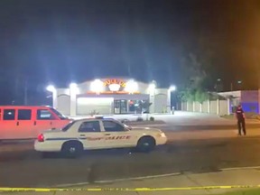 Police are seen near the scene of a drive-by shooting at a liquor store in Shreveport, Louisiana, U.S., April 18, 2021.