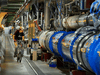 A worker inspects the European Organisation for Nuclear Research (CERN) Large Hadron Collider in 2013.
