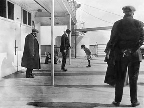 In this photo taken early in the Titanic's maiden voyage, passenger Douglas Spedden can be seen playing with his top on the ship's promenade deck. The photographer. Frank Brown, would disembark in Ireland and avoid the sinking.