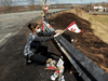 Care worker and first responder Alicia Cunningham adjusts a Canadian flagat a makeshift memorial for slain RCMP Const. Heidi Stevenson.