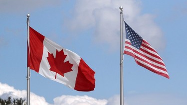 A U.S. and a Canadian flag flutter at the Canada-United States border crossing at the Thousand Islands Bridge, which remains closed to non-essential traffic to combat the spread of COVID-19 in Lansdowne, Ont., September 28, 2020.