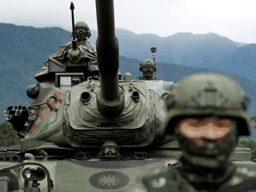 A Taiwanese soldier stands in front of a M60A3 tank during a military drill in Hualien, Taiwan, January 30, 2018.