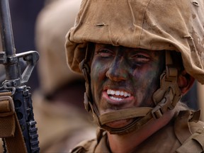 Marine Corps recruit Abigail Ragland, 20, smiles while participating in the gruelling crucible training as her platoon becomes the first women Marines trained at Camp Pendleton. "With so many eyes on us we don't want to be looked at as failures," she said.