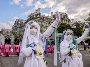 Members of the White Rebels and Extinction Rebellion block 17th Street in Washington, D.C., after dumping cow manure outside the White House on Earth Day to protest U.S. President Joe Biden's climate plan, April 22, 2021.