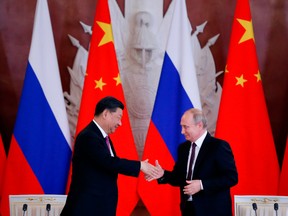 Russian President Vladimir Putin, right, and his Chinese counterpart Xi Jinping shake hands in Moscow in 2019.