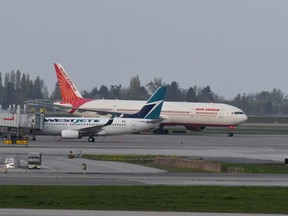 Air India flight 185 arrives from New Delhi, narrowly beating the cut-off after Canada's government temporarily barred passenger flights from India and Pakistan for 30 days, at Vancouver International Airport in Richmond, British Columbia, Canada April 23, 2021.