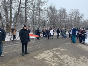 People gather outside GraceLife Church near Edmonton on April 11, 2021, the first Sunday after Alberta Health Services closed the building and its grounds for violations of COVID-19 health orders.