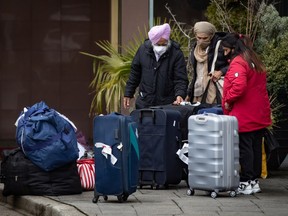 Travellers arrive at a government-authorized COVID-19 quarantine hotel in Richmond, B.C. on Sunday, February 28, 2021. Travellers arriving in Canada are required to reserve a government-authorized hotel for three nights and stay at the hotel while awaiting the results of a COVID-19 test done upon arrival in the country.