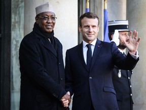 France's President Emmanuel Macron welcomes Chad's President Idriss Deby as he arrives at the Elysee presidential palace for a lunch as part of the Paris Peace Forum in November 2019.