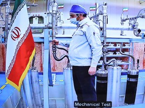 A handout picture provided by the Iranian presidential office on April 10, 2021, shows a grab of a videoconference screen of an enginere inside Iran's Natanz uranium enrichment plant, shown during a ceremony headed by the country's president on Iran's National Nuclear Technology Day, in the capital Tehran.