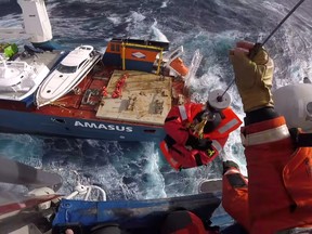 Head cam footage of a search and rescue member hoisting a crew member from Dutch cargo ship Eemslift Hendrika during an evacuation in stormy weather off the coast of Norway in the North Sea, April 5, 2021 in this still image obtained from social media video.