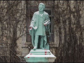 File: A statue of Egerton Ryerson, Founder of The School System Of Ontario with protest graffiti stating "Land Back" on Thursday February 18, 2021.