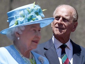 Queen Elizabeth and Prince Philip, the Duke of Edinburgh, take part in the unveiling of a statue of jazz legend Oscar Peterson at the National Arts Centre in Ottawa on Wednesday, June 30, 2010.