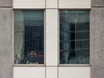A man looks at his phone at a quarantine hotel near Toronto Pearson International Airport in Mississauga, Ontario, on Feb. 24, 2021.