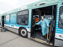 Health-care workers conduct rapid COVID-19 screening on a city bus in the Waterloo Region Friday. The rollout of rapid testing in Canada has been slow, but that is changing.