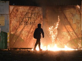 Nationalists and Loyalists riot against one another at the Peace Wall interface gates which divide the two communities on April 7, 2021 in Belfast, Northern Ireland.