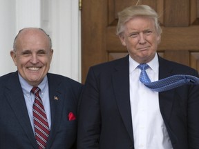 In this file photo taken on November 20, 2016 President-elect Donald Trump meets with former New York City Mayor Rudy Giuliani at the clubhouse of the Trump National Golf Club in Bedminster, New Jersey.