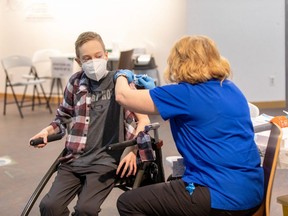 Riley Oldford, 16-years-old and who suffers from cerebral palsy, is the first N.W.T. youth to get the Pfizer vaccine. He receives the needle from Nurse practitioner Janie Neudorf in Yellowknife on Thursday, May 6, 2021