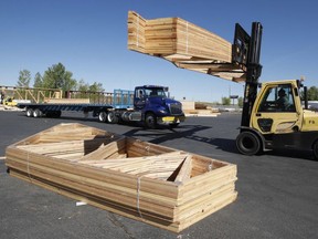A worker loads finished trusses for homes onto a truck in Utah. Lumber prices have skyrocketed over the last several months.