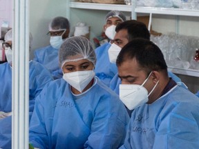 Doctors and health officials work at converted COVID-19 coronavirus care centre, in New Delhi. on July 6, 2020.