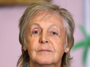 Sir Paul McCartney poses for photograph at the "Hey Grandude!" book signing at Waterstones Piccadilly in London, England