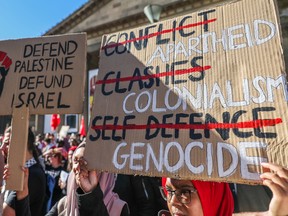 Pro-Palestinian protesters hold placards during a rally on May 22, in Melbourne.