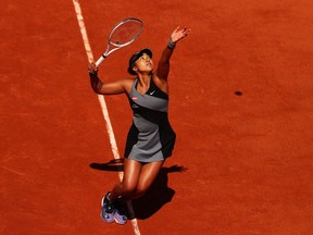 Naomi Osaka of Japan serves in her First Round match against Patricia Maria Tig of Romania during Day One of the 2021 French Open at Roland Garros on May 30, 2021, in Paris, France.