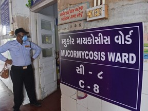 A security guard stands at the entrance of a ward for people infected with Black Fungus, scientifically known as Mucormycosis, a deadly fungal infection, at a civil hospital in Ahmedabad, India, on May 23, 2021.