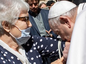 Pope Francis kisses the concentration camp tattoo of former inmate Lidia Maksymowicsz , a Polish-Belarusian Holocaust survivor of the Auschwitz-Birkenau camp, during the Pope's weekly general audience at San Damaso courtyard in the Vatican.