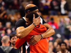 Vince Carter hugs Toronto Raptors guard Kyle Lowry as he congratulates him on becoming the all-time franchise leader in assists during a break in play on Jan.28, 2020.