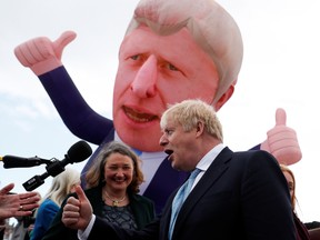 British Prime Minister Boris Johnson, right, and newly elected MP for Hartlepool Jill Mortimer speak, with an inflatable figure depicting Johnson in the background, at Jacksons Wharf Marina in Hartlepool, U.K., on May 7.