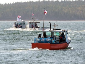 Members of the Potlotek First Nation, a Mi'kmaq community, set out from the wharf in St. Peter's, N.S., as they participate in a self-regulated commercial lobster fishery on Oct. 1, 2020.