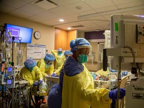 Nurses finish proning a COVID-19 patient inside the intensive care unit of Humber River Hospital in Toronto on April 19, 2021.