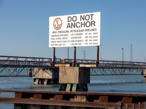 A signpost marks the presence of high pressure petroleum pipelines including Enbridge's Line 5 pipeline, which Michigan Governor Gretchen Whitmer ordered shut down in May 2021, in Sarnia, Ontario, Canada March 20, 2021.