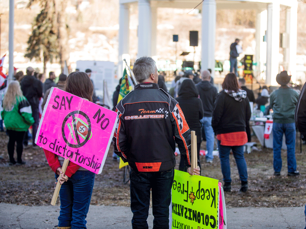 People protest against mandatory mask laws in Saskatoon on March 20, 2021.